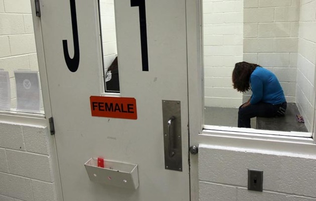 A woman being held at an ICE detention facility. Photo: Getty Images/John Moore